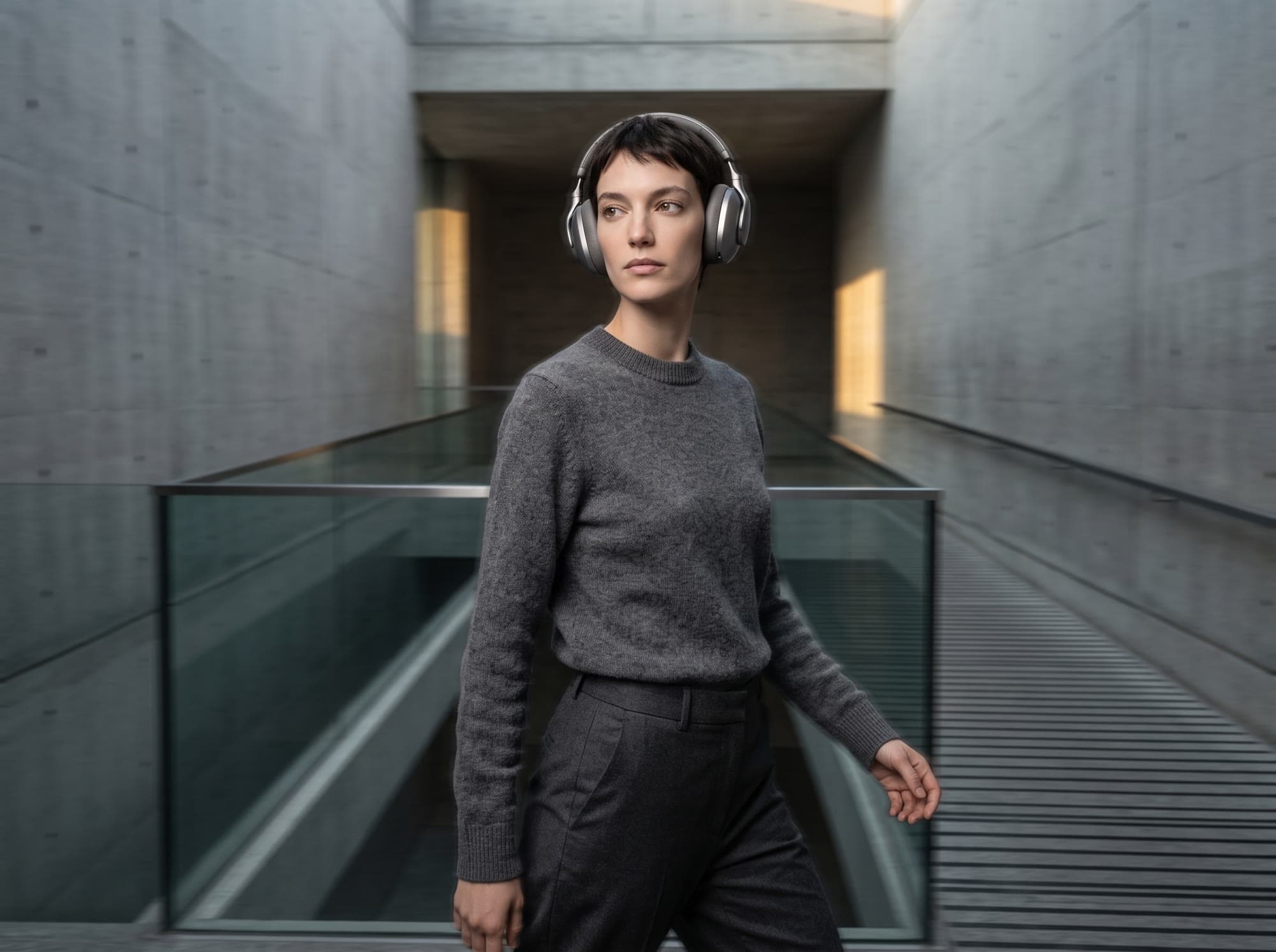 Person walking through a concrete corridor wearing AERA ONE